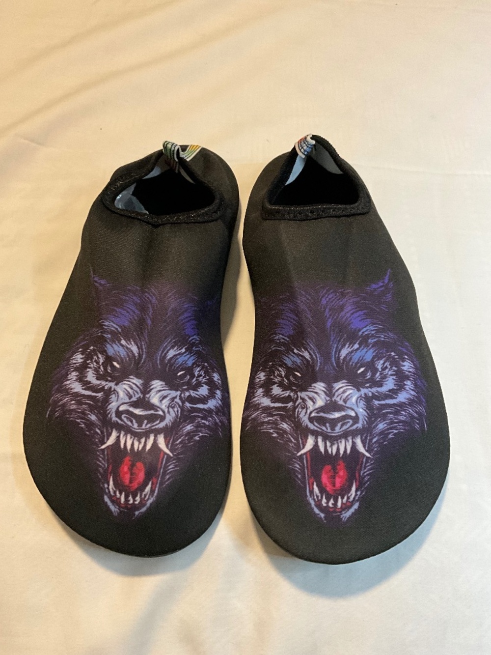 black water shoes featuring a purple wolf print design
